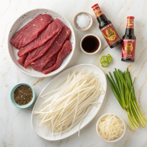 Beef chow fun ingredients including rice noodles and marinated beef