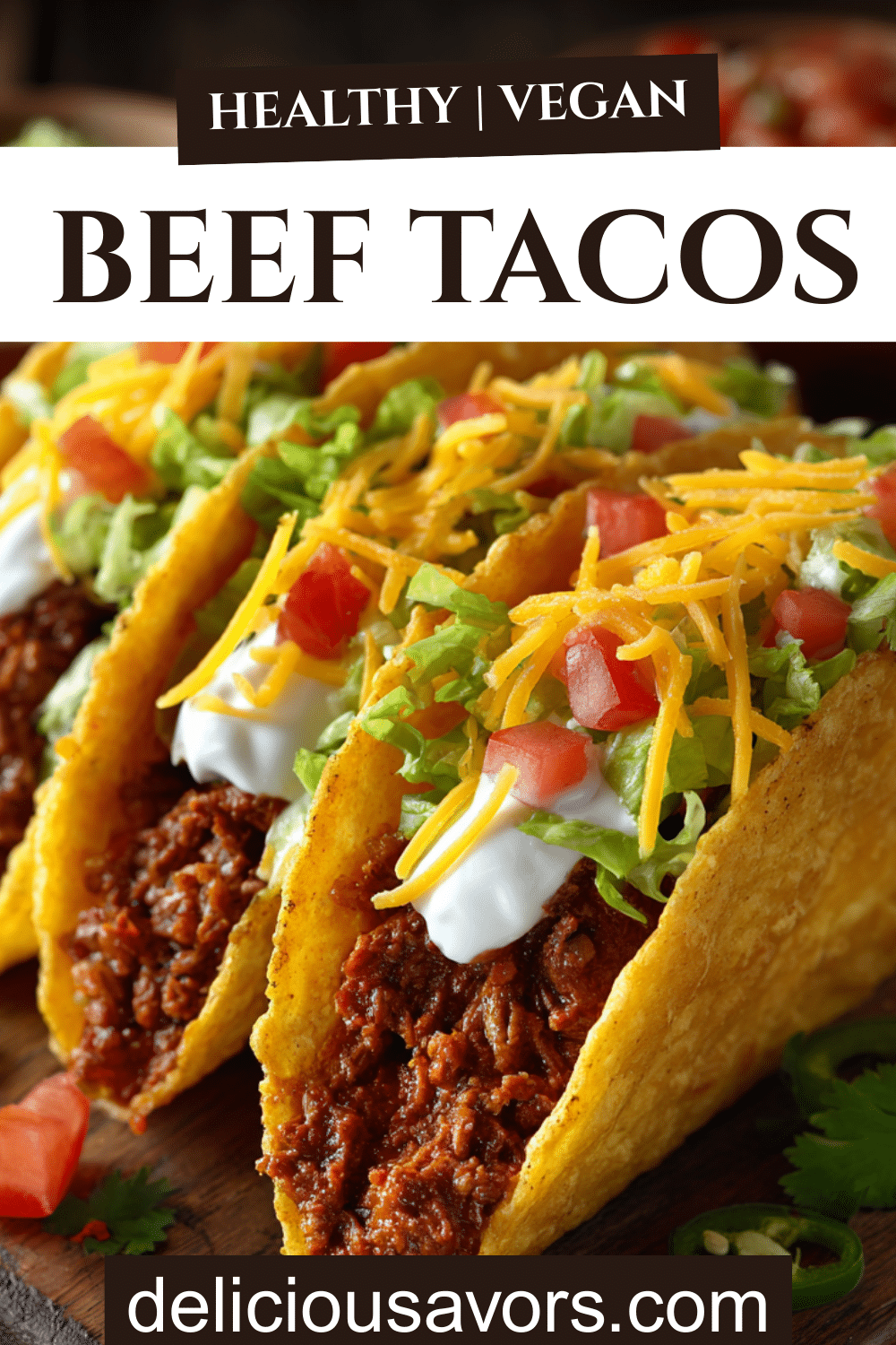 Classic beef tacos in crispy shells filled with seasoned ground beef, melted cheese, lettuce, tomatoes, and sour cream arranged on a platter with colorful toppings.