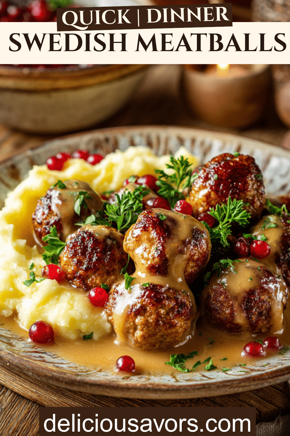 A closeup of Swedish meatballs covered in creamy gravy, plated with mashed potatoes and lingonberries, on a rustic dish.