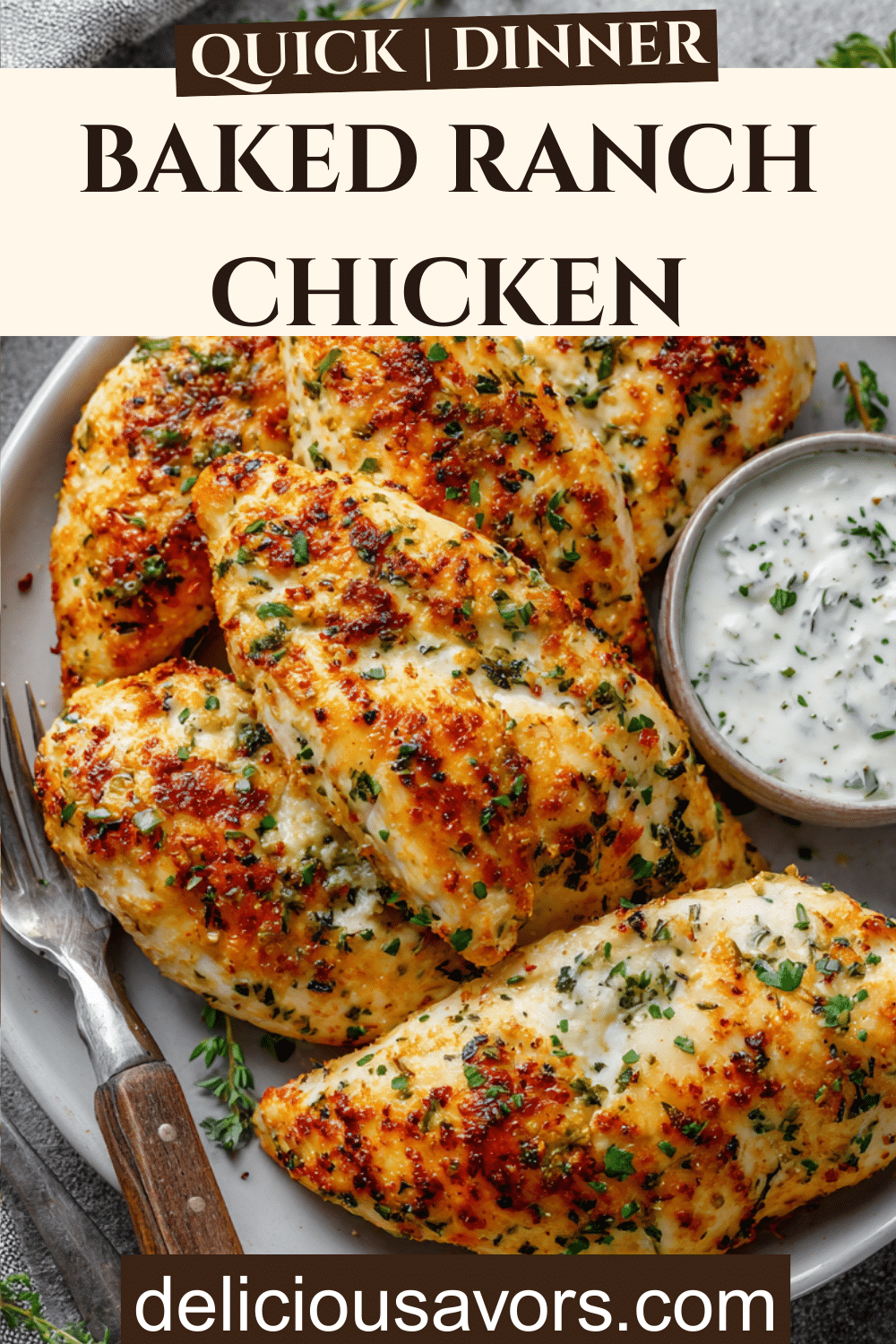 Baked ranch chicken breasts with golden crust on a plate, garnished with herbs and ranch dip.