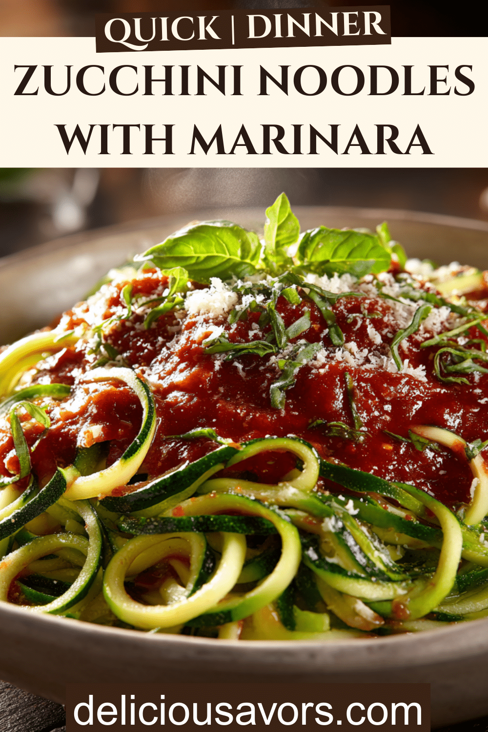 Bowl of zucchini noodles with thick tomato marinara sauce, fresh basil, and Parmesan cheese.