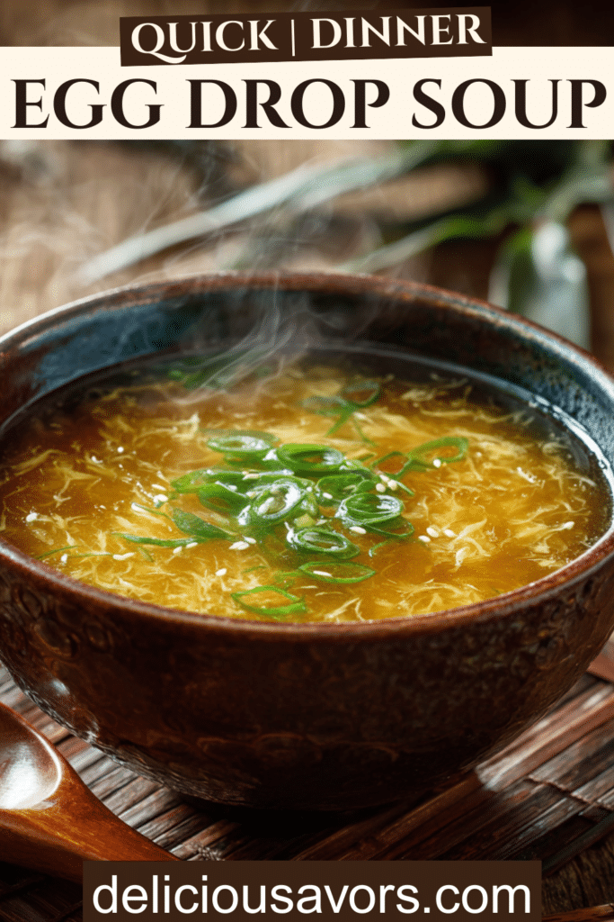 Golden egg drop soup in ceramic bowl with silky egg ribbons and scallion garnish on wooden table