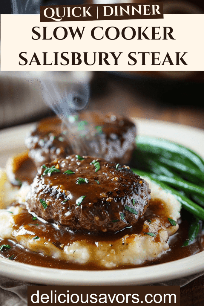 Slow cooker salisbury steak with rich brown gravy served over mashed potatoes with green beans on rustic white plate
