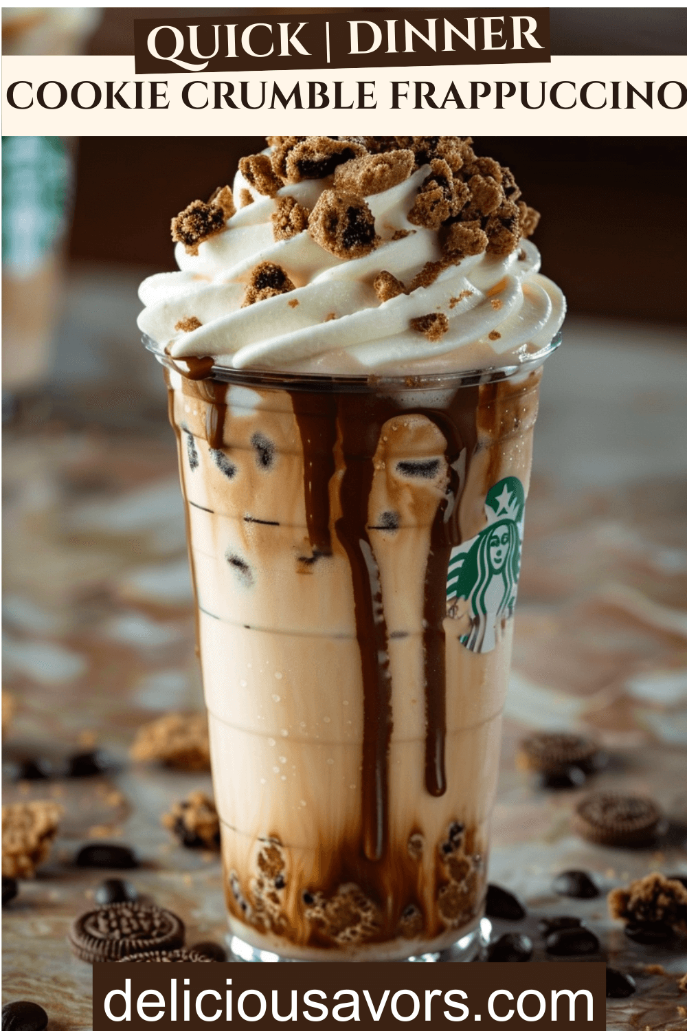 Chilled Chocolate Cookie Crumble Frappuccino in tall glass topped with whipped cream, chocolate drizzle, and OREO crumbs against coffeehouse background, Starbucks copycat iced coffee drink
