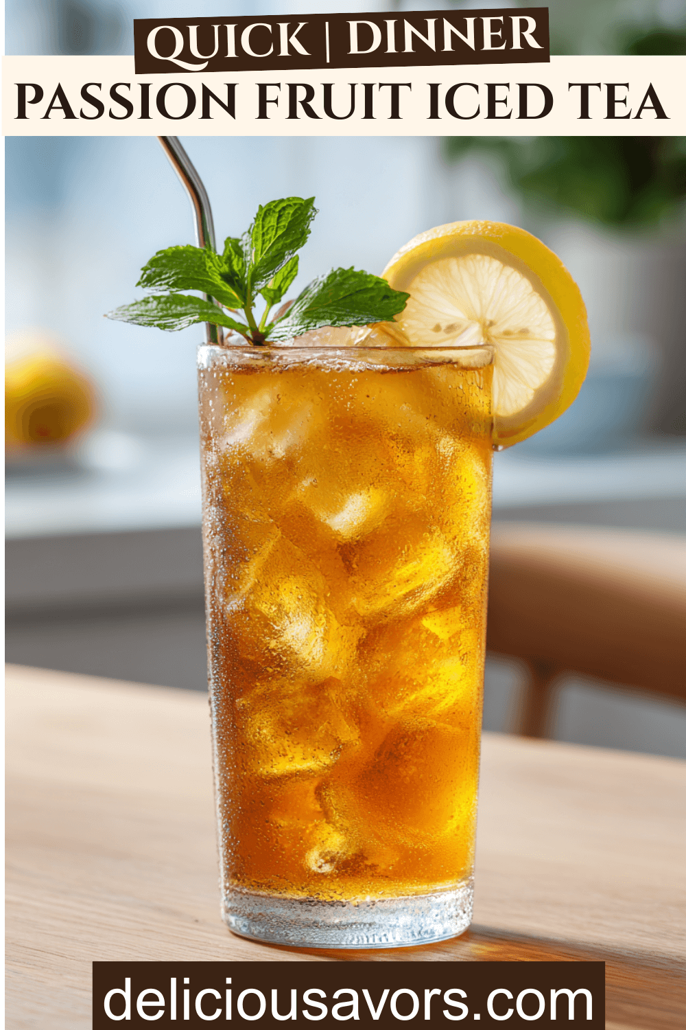 Tall glass of passion fruit iced tea over ice with lemon slice and mint garnish on a wooden table.