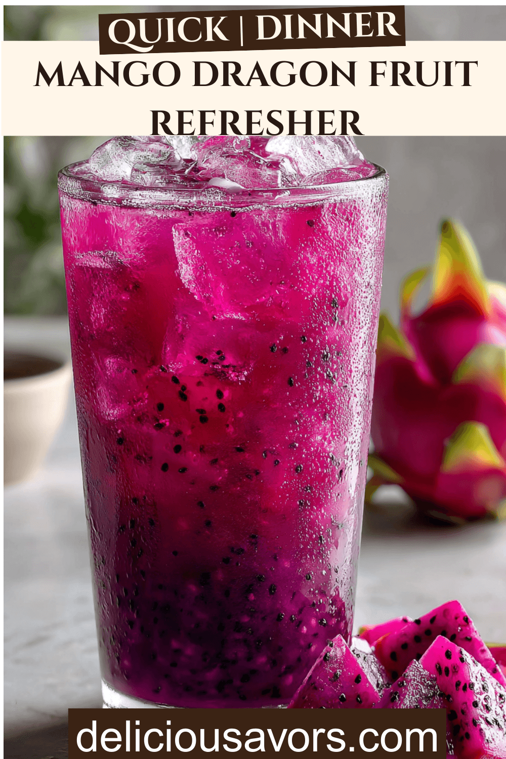 Vibrant pink Mango Dragon Fruit Refresher in tall glass with floating freeze-dried dragonfruit pieces, condensation droplets, fresh mango garnish on marble surface, copycat Starbucks drink