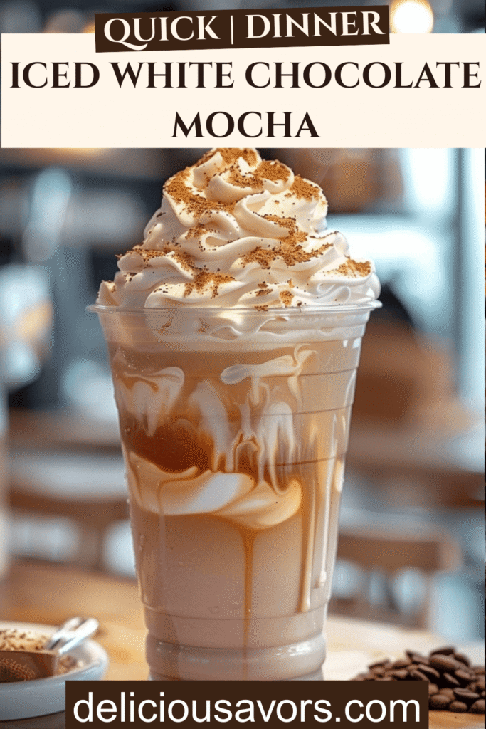 Closeup of layered Iced White Chocolate Mocha in clear glass with whipped cream topping and drizzle, Starbucks copycat drink with condensation beads, perfect iced coffee aesthetic