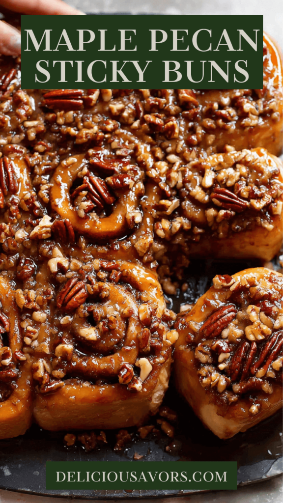 Homemade maple pecan sticky buns with caramelized topping on a white serving platter, featuring gooey maple syrup glaze and toasted pecans
