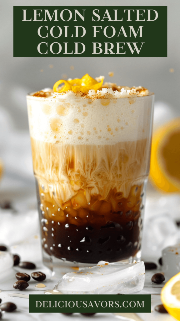 Lemon Salted Cold Foam Cold Brew in clear glass with layered coffee and creamy foam topped with honey drizzle and lemon zest garnish