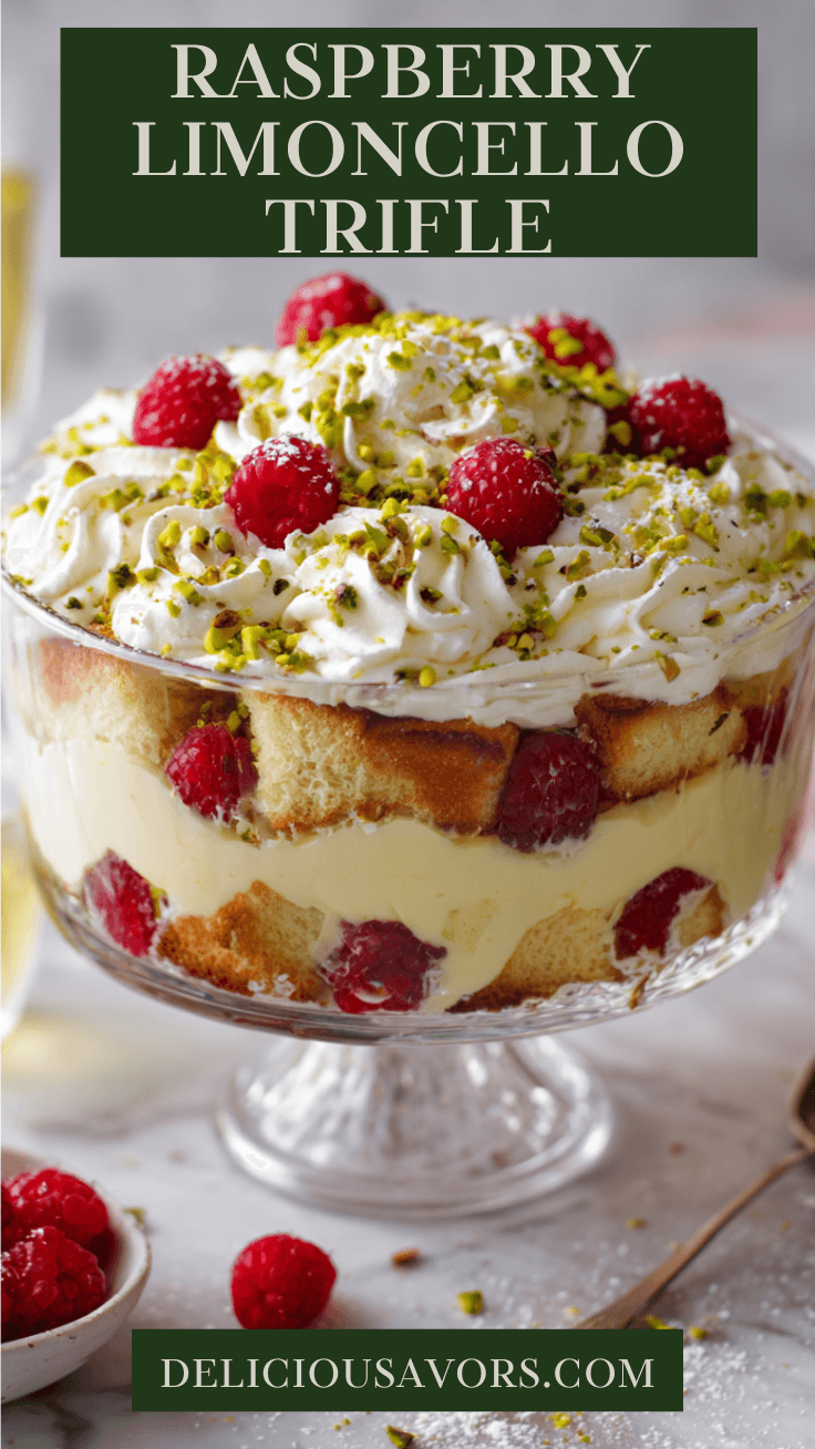 Glass trifle bowl filled with layered raspberry and limoncello trifle made of lemon-soaked cake, mascarpone custard, whipped cream, fresh raspberries, and chopped pistachios on top.