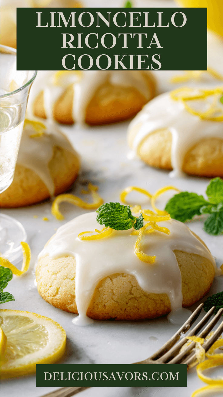 Soft limoncello ricotta cookies with white citrus glaze on marble surface surrounded by fresh lemon slices and mint leaves